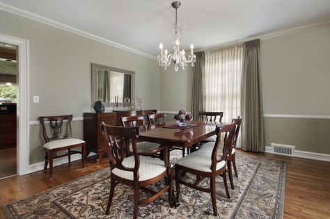 Spacious dining room in green and brown color scheme.