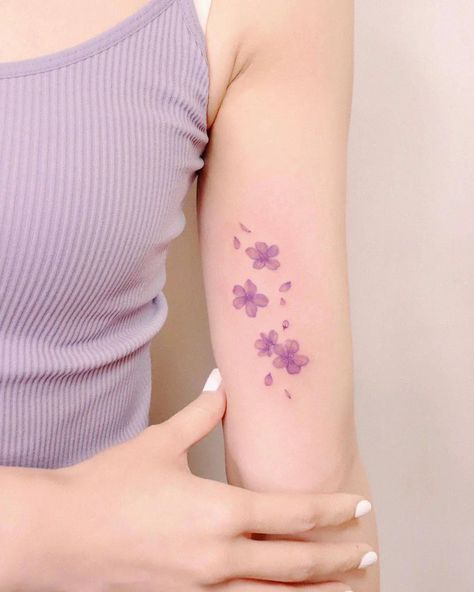 Simple Sakura Tattoo, Light Purple Tattoo, Japanese Wisteria Tattoo, Cherry Blossom Tattoo Forearm, Seventeen Inspired Tattoos, Cherry Blossom Tattoo Minimalist, Purple Tattoo Ideas, Purple Flower Tattoo, Minimalist Flower Tattoo