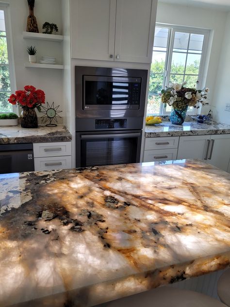 Patagonia countertops back-lit light under lit white cshaker cabinets brushed nickel hardware pulls Backlit Island, Penthouse Decor, Barbie Painting, Stone Countertops Kitchen, Luxury Living Room Inspiration, Diy Kitchen Countertops, Epoxy Ideas, Floor Renovation, Quartzite Countertops