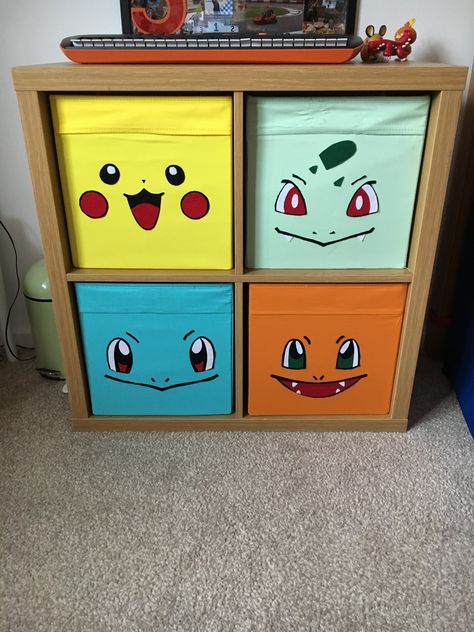 Ikea Kallax unit with Drona boxes and felt “first partner” Pokemon faces applied with heat n bond.. Pokemon Man Cave, Pokemon Furniture Diy, Pikachu Room Ideas, Pokemon Mural Bedroom, Pokemon Nursery Ideas, Pokemon Room Decor Ideas, Pokemon Theme Bedroom, Pokemon Organization Ideas, Pokémon Theme Room