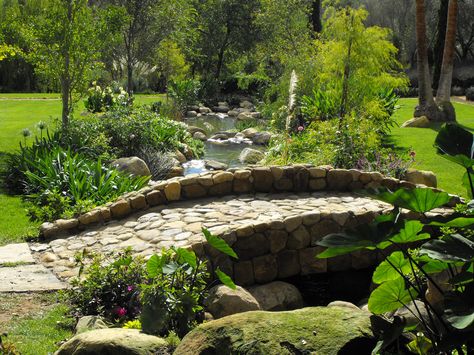 Stone Bridge over man-made creek Backyard Stream, Pond Bridge, Affordable Backyard Ideas, Building A Pond, Fountains Backyard, Natural Pond, Pond Landscaping, Backyard Water Feature, Easy Backyard