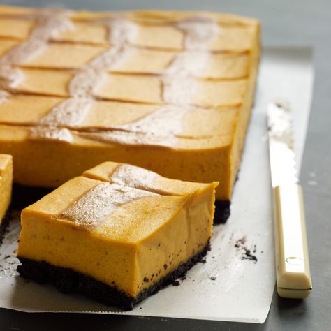 Pumpkin Cheesecake Bars with Caramel Swirl | Food & Wine Bars With Caramel, Chocolate Pumpkin Cheesecake, Thanksgiving Desserts Pumpkin, Fun Thanksgiving Desserts, Pumpkin Cheesecake Bars, Chocolate Pumpkin, Chocolate Crust, Pumpkin Recipes Dessert, Homemade Caramel