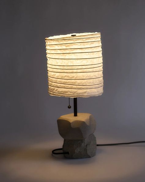 Limestone Lamp No.03 One block of stone, split and stacked. Shoji and reed lampshade, made in-studio. A real, physical object. The top half of the stone is gesturally carved, one kind of human intervention. The bottom half is faced, exposing a rough texture. This is another kind of human intervention. I recently read In Praise of Shadows and wanted to work with some of the materials/themes the author wrote about. The shade is warm and alive, as hoped for. #stonecarving #collectibledesign ... Reed Lamp, In Praise Of Shadows, Stone Carving, Lamp Shade, Shades, Carving, Texture, Design