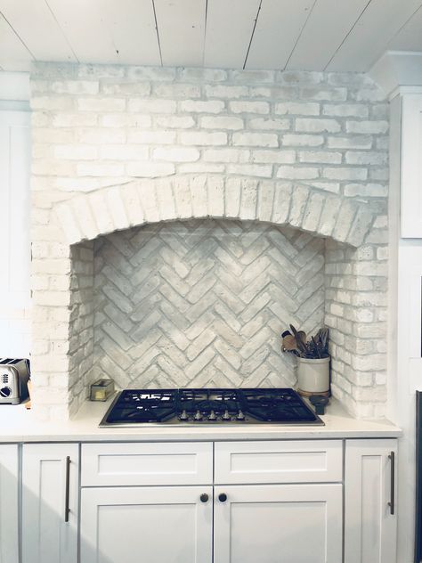 White brick veneer kitchen hood surround. Brick laid in a herringbone pattern behind the stove Brick Kitchen Range Hood, Brick Range Surround, Brick Kitchen Hood Surround, Brick Stove Surround Kitchen Range Hoods, Brick Around Stove In Kitchen, Brick Oven Hood, Brick Hood Vent, Brick Stove Hood, Brick Vent Hood Kitchen