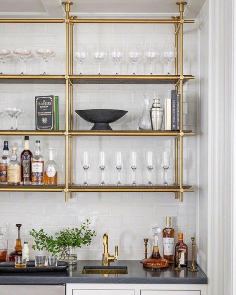 An elegant bar shelving solution, designed by Luxe Living Interiors and made by Amuneal. (Photo shared by Gunn Construction & Building) Gold Shelves For Bar, Glass Shelves Bar, Brass Shelves Bar, Bar Shelves Brass, Metal And Glass Bar Shelving, Brass And Glass Bar Shelving, Bar Shelving, Serving Station, Brass Shelving