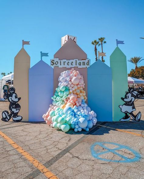 Mandala Sky | Event Design on Instagram: "Welcome to SOIREELAND! 🏰💫 . . It’s a Pastel Disney heaven with some vintage vibes! ✨ - Venue/ Event: @shopsmallsoiree - Design/ Styling: @mandalasky_ - Balloon decor, custom panels and props: @mandalasky_ - Vinyl decals: @kraftzandco . . #disneyland #vintagedisney #vintagedisneyland #retromickey #mickey #disney #disneyballoons #disneydecor #disneyevents #disneylover" Disney Backdrop Photo Booths, Vintage Disney Balloon Garland, Vintage Disneyland Backdrop, Disney Day Decorations, Disney Main Street Birthday Party, Disney Event Ideas, Vintage Disneyland Centerpiece, Disney Party Backdrop, Classic Disney Birthday Party