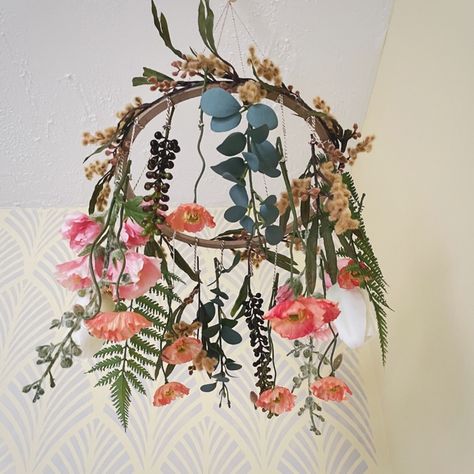 The mobile includes a combination of silk and artificial flowers mirroring the spring blooms you might find growing outside. Poppies, mimosa, tulips, hollyhock and eucalyptus dance together as they dangle down from the spherical structure holding them together. The mobile helps you and your baby to connect with nature through each unique bloom.

#babynursery #nurseryinspo #nurserydecor #expecting #babyprep #motherhood #parenthood #upcycle #babymusthaves Wild Flower Baby Mobile, Wild Flower Theme Nursery, Wildflower Mobile Nursery, Dried Flower Nursery, Wildflower Theme Nursery, Girl Nursery Wildflower, Flower Garden Nursery Theme, Nursery Wildflower Theme, Baby Girl Nursery Wildflower Theme