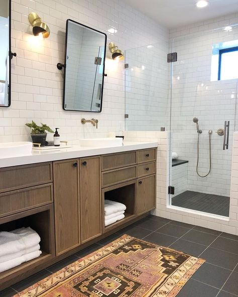 bathroom with white subway tiles and half walls around a shower in the corner. Double sink vanity with his and her mirrors and wall sconces Faucet Hardware, Modern Cabinet Knobs, Best Kitchen Design, Becki Owens, Jack And Jill Bathroom, Chrome Faucet, Design A Space, White Subway Tile, Bathroom Sconces