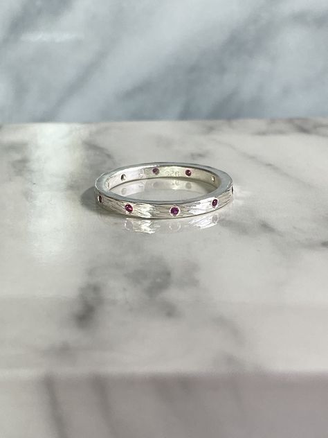 This sterling silver ring is 2mm wide and has 10 flush set, round 1.25mm rubies, .08ctw, evenly spaced around the pancake rocks textured band.  This texture was inspired by the Punakaiki Pancake Rocks on the South Island of New Zealand. The ring is perfect for wearing alone, stacking with other rings, and as a wedding band.  It is a size 7 but I would be happy to make one in your size or with other stones of your choice or in 18k gold. Silversmithing Jewelry, Rock Textures, Georgetown Tx, Indicolite Tourmaline, Stack Ring, Silver Stacking Rings, Europe Trip, Red Band, South Island