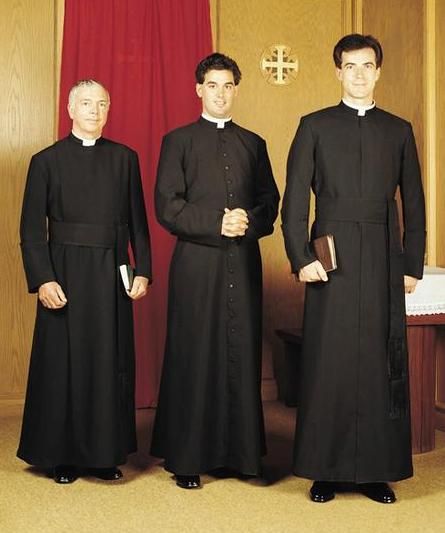 After the Reformation, councils of the Catholic church deemed that priests wear cassocks. Cassocks, or vestis talaris in Latin, are black, ankle length robes with deep skirts. Cassocks derive from early “closed clothing” of ancient Rome and into the Byzantine and early Christian periods; the tunica tolaris was an ankle length garment, tube-like and closed up the sides. Catholic Clothing, Priest Costume, Balenciaga Black, Art Academy, Plain Black, Dress Code, Computer Components, Costume Design, Wearing Black