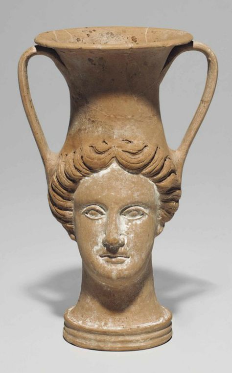 AN APULIAN POTTERY FIGURAL KANTHAROS  CIRCA LATE 4TH CENTURY B.C.  In the form of a female head with center-parted hair, her oval face with thickly-lidded almond-shaped eyes, preserving white slip and traces of pink on the lips Parted Hair, Ancient Greek Pottery, Greek Pottery, Ancient Greek Art, Greek Vases, Face Vase, Ancient Pottery, Ceramic Artwork, Tanah Liat