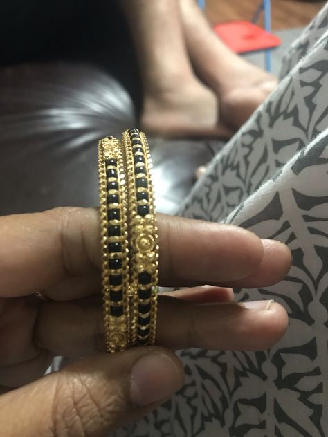 India gold bangle with black beads Karimani Bangle Designs, Black Beads Bangles Gold Indian, Bengali Bangles, Black Bangles, Baby Jewelry Gold, Gold Bangles Indian, Hand Chain Jewelry, Gold Bangles For Women, Black Beads Mangalsutra Design