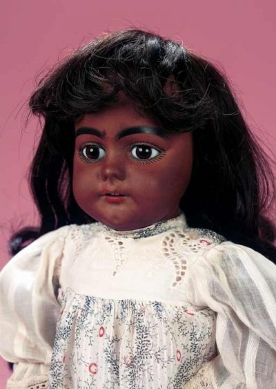 Simon and Halbig, circa 1890. Bisque socket head with rich brown complexion, brown glass inset eyes with paperweight like effect, thick black eyeliner, black curly lashes, black brush-stroked brows, accented nostrils, open mouth, shaded and outlined lips, four porcelain teeth, pierced ears, black human hair wig, composition and wooden ball-jointed body, antique costume. Emily Collins, American Cloth, Dolls And Daydreams, Glass Dolls, Doll Design, Black Americana, American Theme, African American Dolls, Black Curly