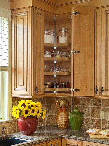 A lazy Susan maximizes corner cabinet space near the window. The basic rotating-tray idea has been around for hundreds of years, yet it remains a proven storage solution for otherwise dead-end kitchen intersections. Kitchen Corner Cupboard, Kitchen Cabinet Storage Solutions, Kitchen Corner Storage, Cabinets Corner, Corner Storage Cabinet, Corner Kitchen Cabinet, Kabinet Dapur, Corner Cupboard, Kitchen Corner