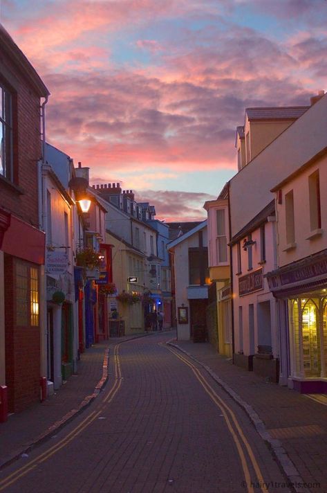 Sunset on a Tenby Street Wales Aesthetic, Tenby Wales, Sunset Street, Pink Street, Clouds In The Sky, Girls Holiday, Spotify Covers, Big Cities, Love Backgrounds