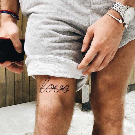 Word ‘Love’ tattooed above the right knee Tattoos Knee, Thigh Tattoo Simple, Front Thigh Tattoos, Above Knee Tattoo, Small Thigh Tattoos, Tattoo Knee, Upper Leg Tattoos, Thigh Tattoo Men, Knee Tattoos