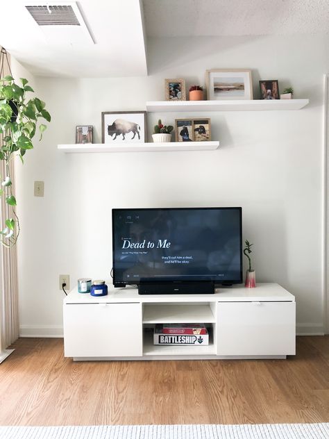 Apartment style, floating shelves, white apartment, gallery wall, floating shelves above tv, floating shelf ideas Gallery Wall Ideas Floating Shelves, Wall Shelves Over Tv, Lounge Room Wall Decor, Floating Shelves Living Room Above Tv, Floating Shelves Behind Tv, Wall Shelves Above Tv, Shelf Above Tv Bedroom, 3 Floating Shelves Living Room, Above Tv Shelves