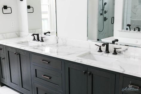 Black and white master bathroom designed with matte black faucets over a white and gray marble vanity countertop and black cabinets. Black Faucets, Black Cabinets Bathroom, Grey Bathrooms Designs, Marble Bathroom Floor, Matte Black Faucet, Black Faucet, Marble Vanity, White Marble Countertops, Vanity Countertop