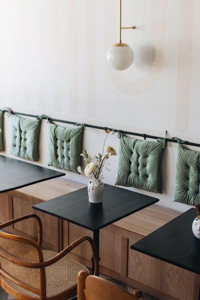 Sarah Sherman Samuel Turned to the Grand Rapids Community for Her Gaia Cafe Design Project Small Cafe Seating Design, Diy Banquette Headboard, Bench Cafe Seating, Small Bar Seating Ideas, Coffee Shop Bench Seating, Coffee Shop Bench, Cafe Bench, Ikea Pillows, Sarah Sherman