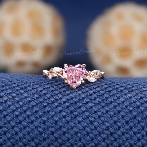 Vintage Heart Peach Sapphire Engagement Ring Rose Gold Moissanite Cluster Wedding Band Art Deco Branch Vine Handmade Promise ring for Women  Jewelry Information: ♡ Handmade, high-quality item ♡ Material: SOLID 14K/18K GOLD ( can be made in yellow/white/rose gold ) ♡ Center stone: Lab Grown Peach Sapphire ♡ Size/Weight: 7mm ♡ Cut - Heart Shaped ♡ Side stones: Moissanite / Natural diamonds ♡ Weight: About 0.09ct ♡ Cut - Marquise and Round Shaped ♡ Band Width: 1.6mm Visit my shop for more jewelry: https://www.etsy.com/shop/acraisejewelry PRODUCTION We are jewelry artisans and manufacturers. Every Jewelry is made from the very scratch, and made by hand and carefully polished especially for you. PAYMENT PLAN We provide Payment plan. Click on the link to find out how it works: www.etsy.com/acrai Pink Sapphire Promise Ring With Diamond Accents, Pink Sapphire Rings With Accent Stones For Promise, Yellow Gold Pink Sapphire Promise Ring, Promise Ring In Yellow Gold With Pink Sapphire, Elegant Pink Gold Sapphire Promise Ring, Peach Sapphire Engagement Ring Rose Gold, Pink Wedding Ring, Wedding Rings Pink Sapphire, Peach Sapphire Engagement Ring