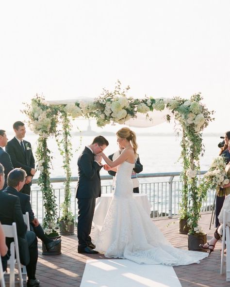 Blossom and Branch designed a ceremonial chuppah with hydrangeas, roses, Queen Anne's lace, jasmine vines, berry branches, and trailing greenery. A white cloth was laid over the top to shield the bride and groom from the sun. Summer Wedding Chuppah, Wedding Arch White Flowers, Chuppah With Hanging Flowers, Summer Chuppah, Chuppah With Blue Flowers, Wedding Arch White, Non Traditional Chuppah, Jasmine Vines, Branch Arch Wedding