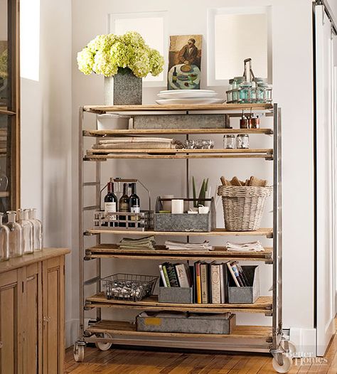 An antique wood-and-metal baker’s rack adds an industrial edge and limitless possibilities for storage. Kitchen Corner Shelving Ideas, Utensils Storage Ideas, Traditional Pantry, Office Paperwork, Freestanding Pantry, Repurposed Metal, Industrial Cart, Storage Bookshelf, Baker's Rack