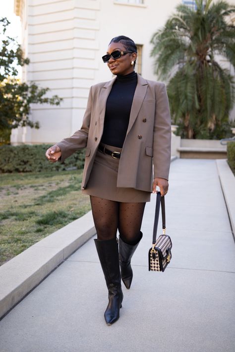 Black women with a short pixie cut wearing a taupe colored mini skirt suit with sheer tights, black knee high boots, houndstooth purse and black sunglasses Skirt Suit Black Women, Women Suit With Skirt, Female Skirt Suits, Suit Skirt Outfit, Debate Outfits, Skirt Suit Outfit, Grad Suits, Winter Mini Skirt, Style A Skirt