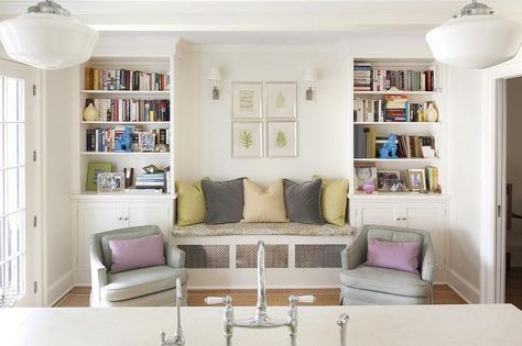 Family room off kitchen features a pair of gray skirted chairs adorned with purple lumbar pillows are placed in front of a built-in bench lined with yellow and grey pillows flanked by tall built-in bookcases with turquoise foo dogs. Bookcase Bench, Basement Conversion, Living Room Wall Units, Living Room Built Ins, Bedroom Cupboard Designs, Transitional Living, Wall Bookshelves, Kitchen Family Rooms, Room Seating