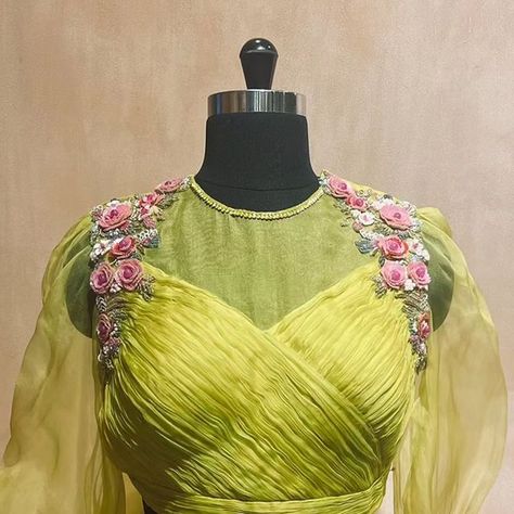 BlouseHousebyMahithaPrasad on Instagram: "Radiant in Neon Green: The Finely Pleated Silk Blouse with Organza Neck and Sleeves designed by Mahitha Prasad breaks stereotypes in the truest sense. Adorned with 3D floral embroidery, created with sequins and pearls, on the shoulders and sleeve cuffs, this masterpiece breaks conventions and defines stereotypes. It's unique colour and contemporary design make it a true showstopper, ensuring you stand out from the crowd. The bow detail on the back wa Mahitha Prasad Blouses, Pleated Blouse Designs, Organza Blouse Designs, Net Saree Blouse Designs, Net Saree Blouse, Ruffle Blouse Designs, Maggam Blouses, Maggam Blouse, Bridal Blouses