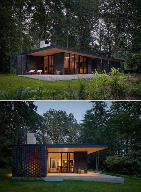 A Black Brick Exterior Is Consistent With The Dark Forest Surrounding This Modern Home Dark Brick Exterior, Black Brick Exterior, Modern Black Houses, Dark House Exterior, Dark Modern House, Black Brick Wall, Mid Century Exterior, House Pics, Modern House Floor Plans