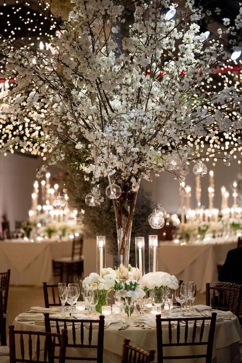 This Candlelit Winter Wedding in Brooklyn Was an Elegant Baby’s Breath Dream - Green Wedding Shoes Winter White Floral Arrangements Wedding, Wedding Ideas Christmas Winter, Elegant Winter Wedding Centerpieces, Winter Wedding Isles, Tall Winter Centerpieces, White Winter Centerpieces, Winter Wedding Floral Centerpieces, Wedding Decor White And Green, Winter Wedding Decorations Elegant