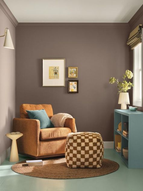 Is it brown? Is it gray? Is it purple? It's Nutshell, the moodiest color in the 2025 color collection. This brown paint with purple undertones is a chic choice on its own, and it grounds the other colors in the palette when they're used in the same space. (It's shown in this cozy sitting area with Quietude on the floor and Delft on the dresser.) Grey Paint With Purple Undertones, Accent Wall Paint Colors, White Upper Cabinets, Warm Paint Colors, Cozy Sitting Area, Paint Color Codes, Blue Green Paints, Hgtv Dream Home, Sherwin Williams Colors