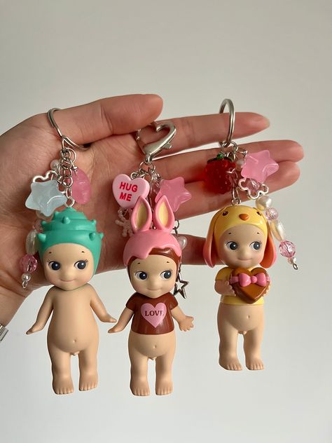 Authentic Sonny Angel Keyrings handmade by me ❤️  Perfect to hang onto your bag 💼 Custom Sonny Angel with your choice of charms! 🫶 If you would like dangly charms please select heart clasp 🎀 All variations will come with 2 charms of your choice or leave it up to me ❤️ Feel free to message me for any other enquires! Five Below Toys, Sonny Angel Keychain Diy, Stuff To Add To Your Wishlist, Sonny Angel Bag Charm, Sony Angel Keychain, Cherry Sonny Angel, Custom Sonny Angel, Girly Presents, Aesthetic Items To Buy