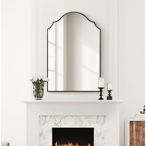 Showcase your modern, elevated aesthetic by hanging the Leanna wall mirror in your home. Inspired by the elegant curvature of sophisticated vintage art pieces, the Leanna features an arched shape with a scalloped edge on either side. Along this beautiful frame, you'll find a lovely satin black finish along with a slight bevel giving the mirror some added dimension. The overall dimensions of the Leanna wall mirror are 24 inches wide by 36 inches tall, making it a stellar statement piece for any wall in your home. Use the lovely Leanna mirror to elevate your living room, bedroom, entryway, or dining room. It captivates your guests as its own focal point or dazzles in a display of multiple mirrors. The ample surface area of this mirror allows it to spread vibrancy and dimension in your home w Mirror Above Fireplace Mantle, French Country Vanity, Mirror Above Fireplace, Arch Wall Mirror, Multiple Mirrors, Scalloped Mirror, Modern French Country, Modern Entry, Arch Wall