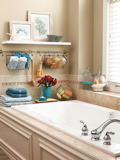 In a master bedroom and bathroom space, carving out extra storage can be as simple as making use of open areas in artful ways. The windowsill and tub deck here offer narrow spaces for practical items, while slim wall stretches are great for hanging rods with baskets and shelves. Bathtub Decor, Bad Inspiration, Decor Baie, Small Bathroom Storage, Creative Storage, Bathroom Redo, Bath Storage, Bath Tub, Bathroom Space