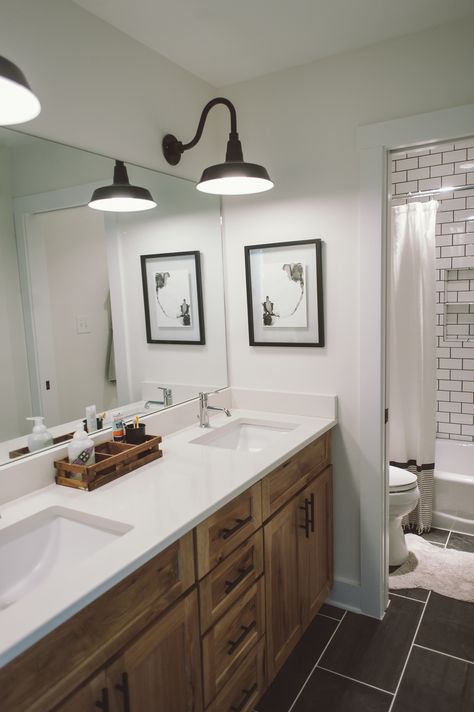 Bathroom Dark Floor Wood Vanity, Double Sink Hall Bathroom, Double Vanity Kids Bathroom, Bathroom Sink Lighting, Narrow Master Bath Layout, Boys Shared Bathroom, Stained Bathroom Vanity, Bathroom Vanity Lighting Over Mirror, Entryway Lights