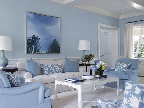 White scalloped coffee table in a white and blue living room featuring blue roll armchairs and a white sofa with blue pillows. Light Blue Living Room, Bold Bohemian, Vaulted Ceiling Living Room, Blue And White Living Room, Earthy Living Room, High Ceiling Living Room, Blue Living Room Decor, Bohemian Rugs, White Sofa