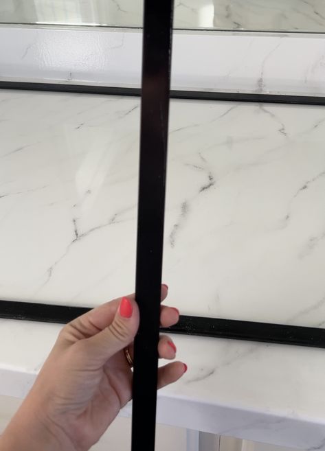 Trim On Bathroom Mirror, Bathroom Mirror Black Metal Frame, Tile Framed Bathroom Mirror, Frame Vanity Mirror Diy, Frameless Mirror Makeover, How To Put Trim Around Bathroom Mirror, Modern Mirror Frame Diy, Diy Vanity Mirror Frame, Black Bathroom Mirror Frame