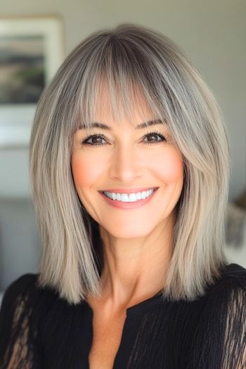 Save this pin for the best hairstyles for women over 50 with bangs. This lob (a.k.a. long bob) is a lesson in airy, understated elegance. The wispy layers create a soft texture that looks and feels light as a feather. Bangs With Side Parting, Half Bangs Haircuts, Hair Styles With Wispy Bangs, Long Bob Wispy Bangs, Long Bob With Bangs Hairstyles, Long Bob Hairstyles With Layers And Curtain Bangs, Bangs Over 50 Medium Hair, Bangs On Small Forehead, Long Bob With Bangs Fine Hair