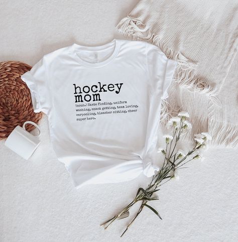 This Hockey mom dictionary shirt is the perfect description of a true hockey mom, a super hero. Tshirt information: This classic unisex jersey short sleeve tee fits like a well-loved favorite. Soft cotton and quality print make users fall in love with it over and over again. These t-shirts have-ribbed knit collars to bolster shaping. The shoulders have taping for better fit over time. Dual side seams hold the garment's shape for longer. Godmother Shirts, Heat Press Vinyl, Hockey Mom, Mama Shirts, T Shirt Mockup, Design Program, Shirt Mockup, Mama Shirt, Godmother