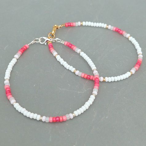 This pink summer seed bead bracelet has been lovingly made using good quality colourful 3mm glass Miyuki and Preciosa seed beads in pinks and white. Available with either 2mm silver or gold Miyuki seed beads to highlight. Threaded on strong stainless steel 7 strand Tiger Tail wire and finished with silver / gold plated wire guardians, a trigger clasp and optional extender chain. Matching necklace available on request. Matching Anklet available on request. More colours and designs can be found at: https://www.etsy.com/uk/shop/CraftHutCornwall BRACELET LENGTHS 6 1/2" Small 7"       Ladies - Small 7 1/2" Ladies - Standard (this is the most common size and generally the size most bracelets are made) 8"       Ladies - Standard Large / Mens - Standard 8 1/2" Ladies - Large / Mens - Standard Larg Cute Handmade Bracelets Beads, Pink Seed Bead Bracelet Ideas, Seed Bead Bracelets For Men, Bracelet Ideas With Small Beads, Matching Seed Bead Bracelets, Seed Bead Inspiration, Anklet Bead Ideas, Bracelet Beads Design, Simple Seed Bead Bracelets