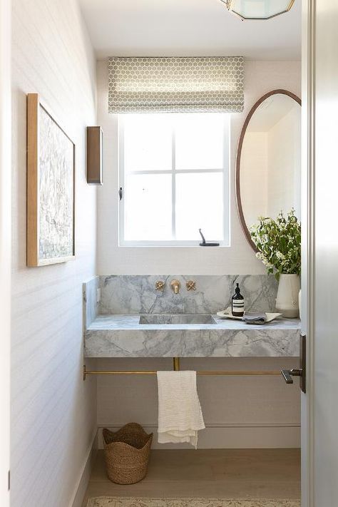 Bathroom features a gray marble sink vanity with brass towel bar and antique brass faucet under a window with oval mirror. Marble Sink Vanity, Brooke Wagner Design, Brooke Wagner, Antique Brass Faucet, Brass Towel Bar, Small Toilet Room, Bathroom Shower Design, Bath Inspiration, Bathroom Retreat