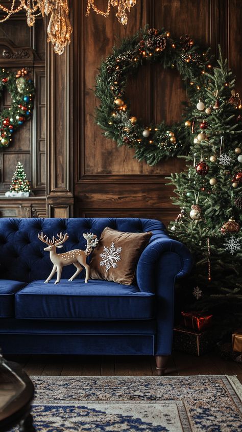 Luxurious blue velvet sofa with deer and snowflake cushions in an opulent Christmas-decorated living room. Blue Sofa Christmas Decor, Blue Velvet Christmas Decor, Dark Blue Christmas Aesthetic, Blue Christmas Living Room, Red Blue Christmas Tree, Blue And Brown Christmas, Cozy Christmas Bedroom Aesthetic, Blue Christmas Theme, Blue Velvet Christmas