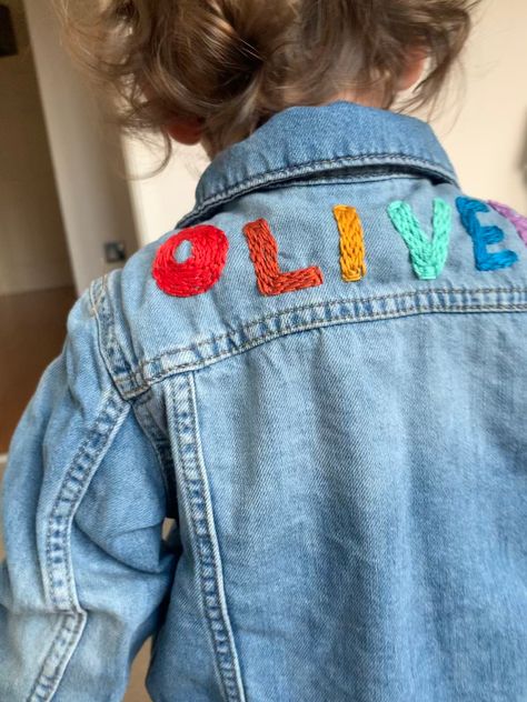 Your little one's name hand embroidered on the back of the denim jacket. Little details such as animals faces, rainbows or flowers can be added at the front or back.  Let me know your idea! Price £35.99 - £49.99 depending on design. Embroidery Sweater Diy, Diy Kids Shirts, Denim Jacket Embroidery, Jean Jacket Diy, Embroidery Jeans Jacket, Jean Diy, Boys Denim Jacket, Embroidered Jean Jacket, Denim Embroidery