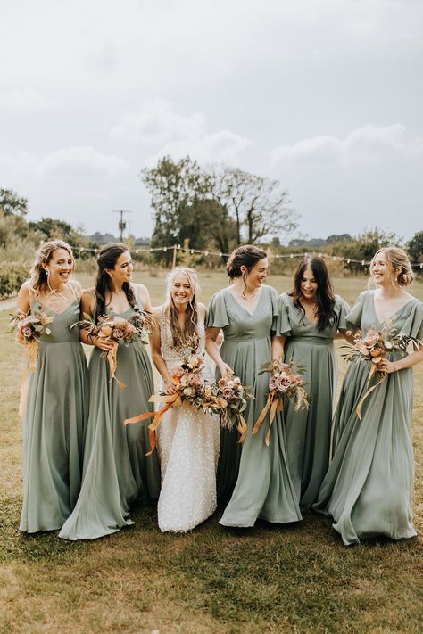 Bridesmaids in thin strap and short sleeve green bridesmaid dresses from TH&TH bridesmaids Boho Rustic Bridesmaid Dress, Boho Green Bridesmaid Dresses, Hippie Bridesmaid Dresses Sage Green, Bridesmaid Dresses Floral Print Green, Sage Green Bridesmaid Dresses Colorful Flowers, Sage Green Bridesmaid Dresses Bright Flowers, Sage Green Bridesmaid Dresses Colourful Flowers, Western Wedding Bridesmaids, Country Wedding Bridesmaids