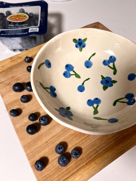 Ceramic bowl painted with blueberries #ceramics #painting #diy #diyideas #fruit #bowl Diy Bowl Painting Ideas, Cute Ceramic Bowls Design, Fruit Plates Ceramics, How To Paint A Blueberry, Painted Cereal Bowl, Fruit Bowls Ceramic Pottery, Blueberry Bowl Ceramic, Fruit Painting Pottery, Pottery Painting Ideas Blueberries