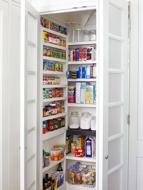 Make the most of a small pantry by outfitting each of the three walls with floor-to-ceiling shelving. Choose deeper, taller shelves for the back wall and short, narrow ledges on each side for cans, bottles, and other pint-size products. Reeded-glass doors hide the pantry's contents but keep the kitchen airy. Installing a pendant light inside the closet makes it easy to grab and go, especially a late-night snack. Vertical Pantry, Melamine Shelves, Walk In Pantry Ideas, Narrow Pantry, Open Pantry, Shallow Shelves, Storage Pantry, Pantry Wall, Pantry Makeover