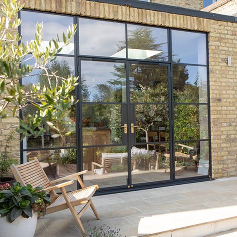 Crittall-style glazing extends from floor to ceiling, adding to the feeling of height and opening up the views of the garden at one of our South Woodford projects. #crittallstyle #oversizedglass #londonarchitects Crittal Extension, Crittal Doors, Aluminium French Doors, Crittal Windows, Aluminium Windows And Doors, French Doors Exterior, Door Images, Steel Windows, Garage Conversion