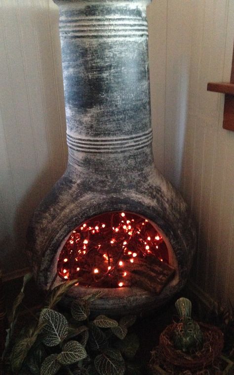 Enjoy my chiminea year round indoors - stacked wood and added a strand of silicone dipped lights Chimnea Outdoor, Christmas Lights Inside, Indoor Christmas Lights, Christmas Light Installation, Hanging Christmas Lights, Holiday Lights, Garden Planters, Outdoor Living Space, Porch Decorating