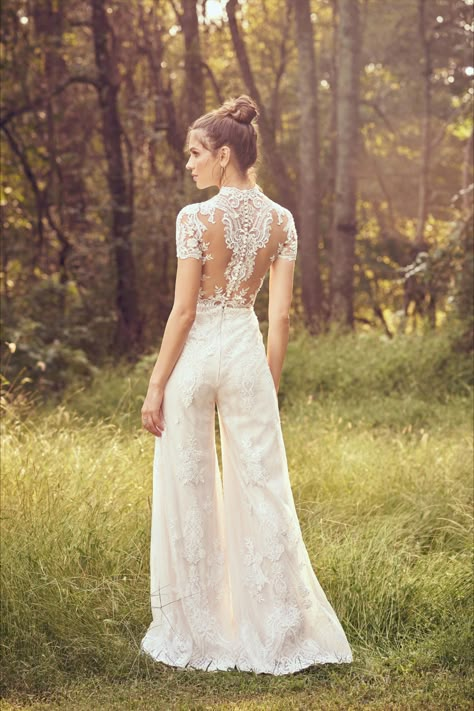 Be ready to dance the night away in this comfortable bridal jumpsuit. With a high neckline, this look features an illusion back and laser cut appliqués. Lace Jumpsuit Wedding, Applique Jumpsuit, Jumpsuit Wedding Dress, Wedding Dress Jumpsuit, Wedding Dress Buttons, Short Sleeve Wedding Dress, Lillian West, High Neck Wedding Dress, Boho Bridal Gowns